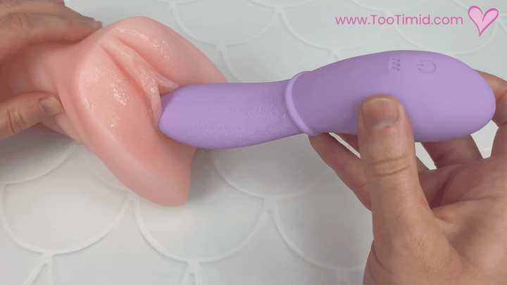 GIF of purple vibrating tongue inserted in beige masturbator