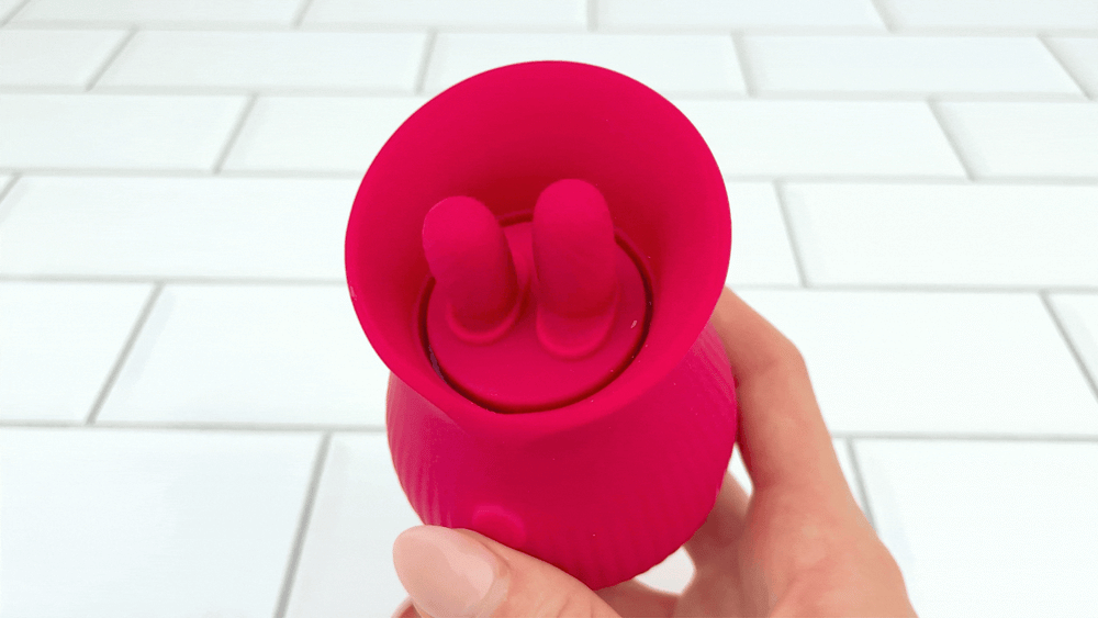 GIF of hand holding Up-Down Clit Sucking Vibrator in motion 