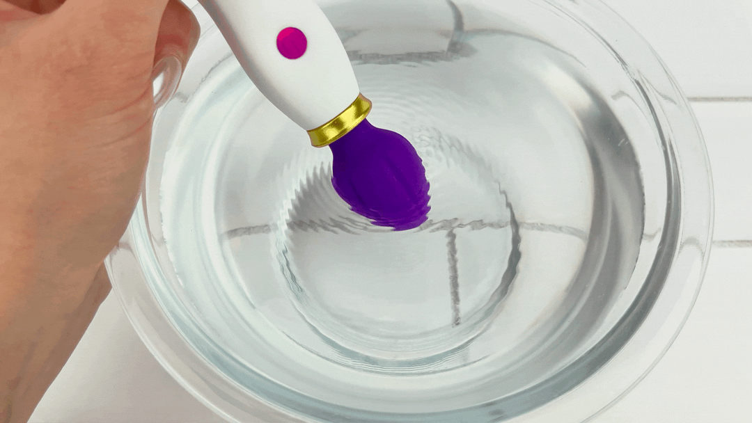 GIF of Petite Handheld Clit Wand tip vibrating in bowl of water NOT WATERPROOF DO NOT USE IN WATER