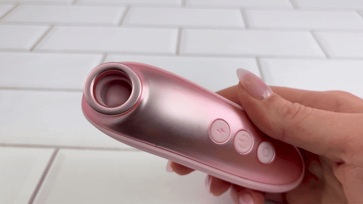 GIF of pink metallic air pulse toy with no attachments being used 