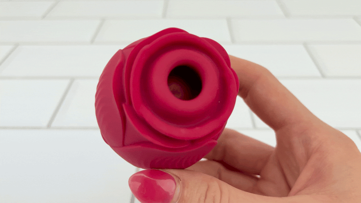 hand holding Rose Sex Toy Air Pulse Stimulator with Thicker Lip view of pulsating pad 