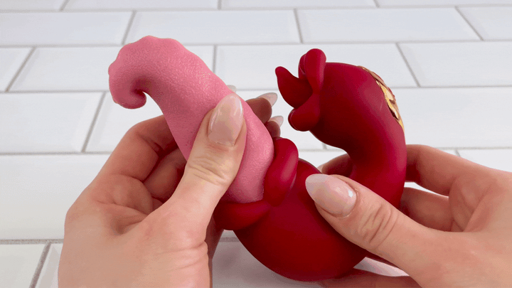 GIF of long tongue's shaft from gyrating tongues toy being squished to show it's softness 