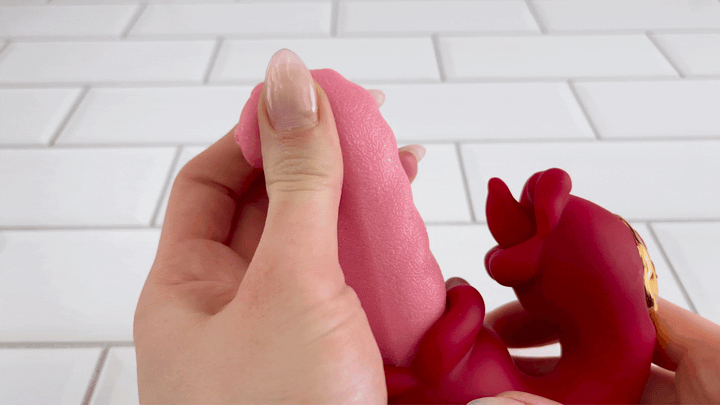 GIF of long tongue's tip from gyrating tongues toy being squished to show it's softness 