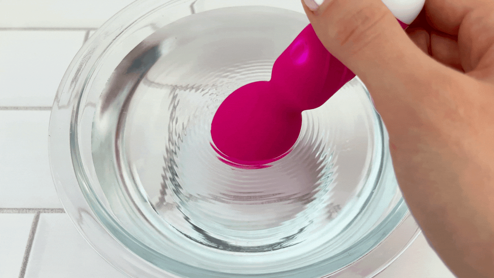 GIF of Wanda Mini Pocket Play Wand Vibrator  on pulsating setting vibrating in bowl of water