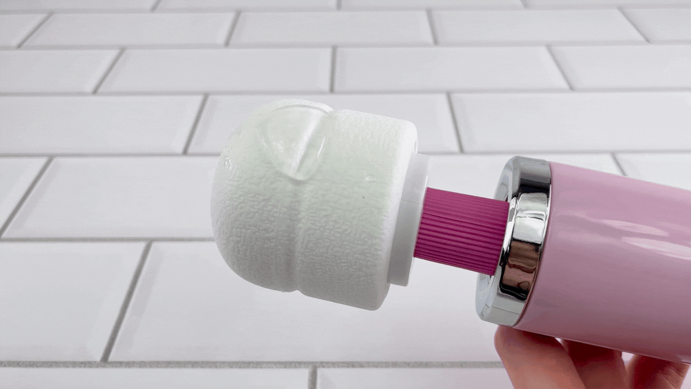 GIF of Desire Rechargeable Massage Wand on low rumbling setting with lubricant 