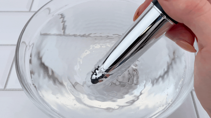 GIF of medium sized bullet vibrating in bowl of water