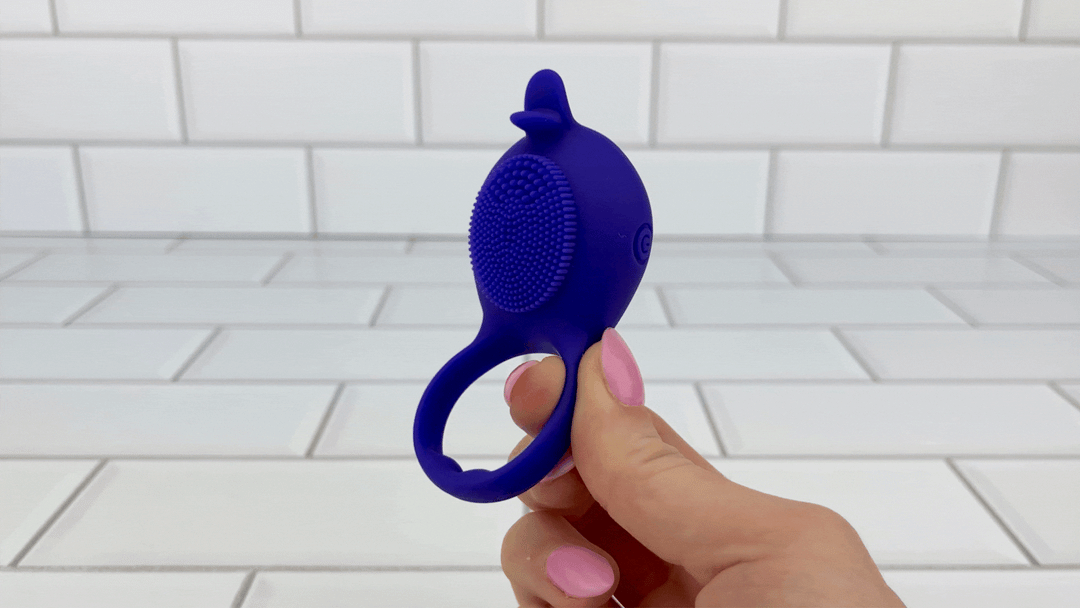 GIF of hand holding vibrating Silicone Clit Stimulating Vibrating Cock Ring For Couples 