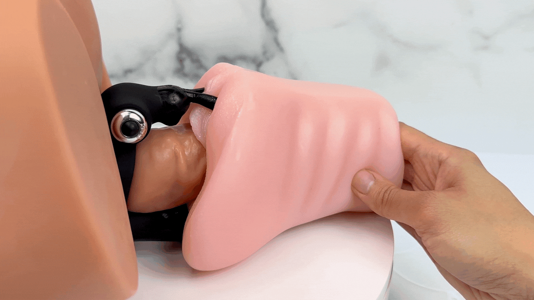 GIF of DP cock ring on a model of a male shaft inserted into a model of a female vagina and anus. Rabbit ears are vibrating on the clitoris