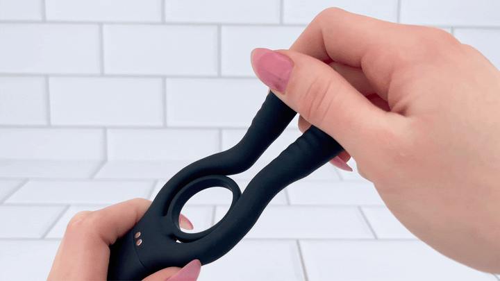 GIF of The Dual-Action Clit and Ball Vibrating Cock Ring ball prongs being bent to show flexibility 