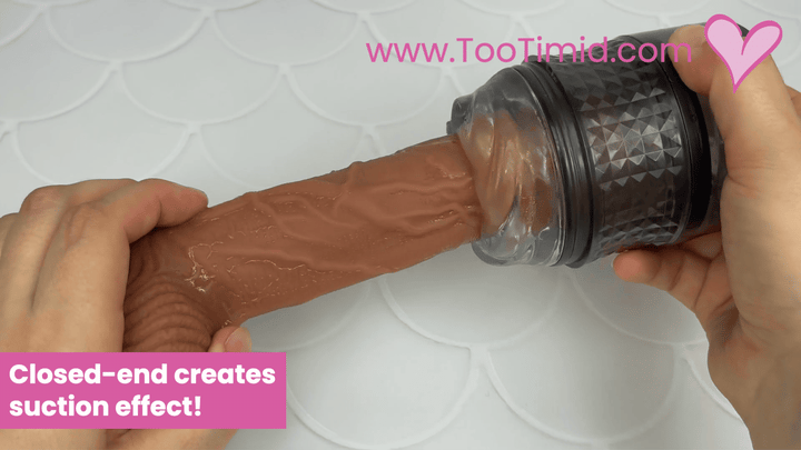GIF of black and clear masturbator stroking on brown dildo