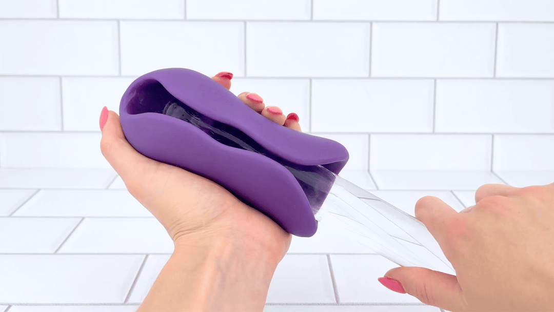 GIF of Ribbed Intensifying Hand Job Stroker Aide glass dildo sliding through 