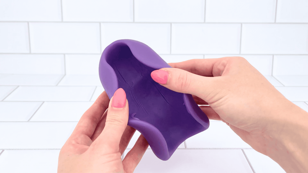 GIF of Ribbed Intensifying Hand Job Stroker Aide flaps stretched open 