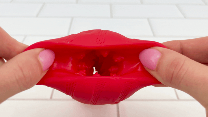 GIF of opening of Bello Male Vibrating Masturbator being stretched to demonstrate soft silicone texture 