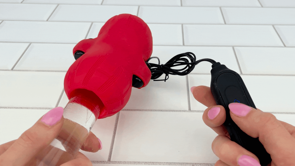 GIF of glass dildo inserted inside Bello Male Vibrating Masturbator being turned on with remote control 