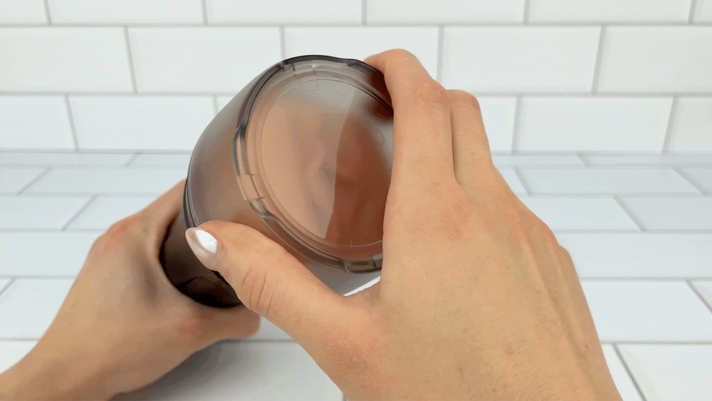 GIF of cap being taken off of silver bullet being placed at tip of Eachna Realistic Vaginal Masturbator sleeve  