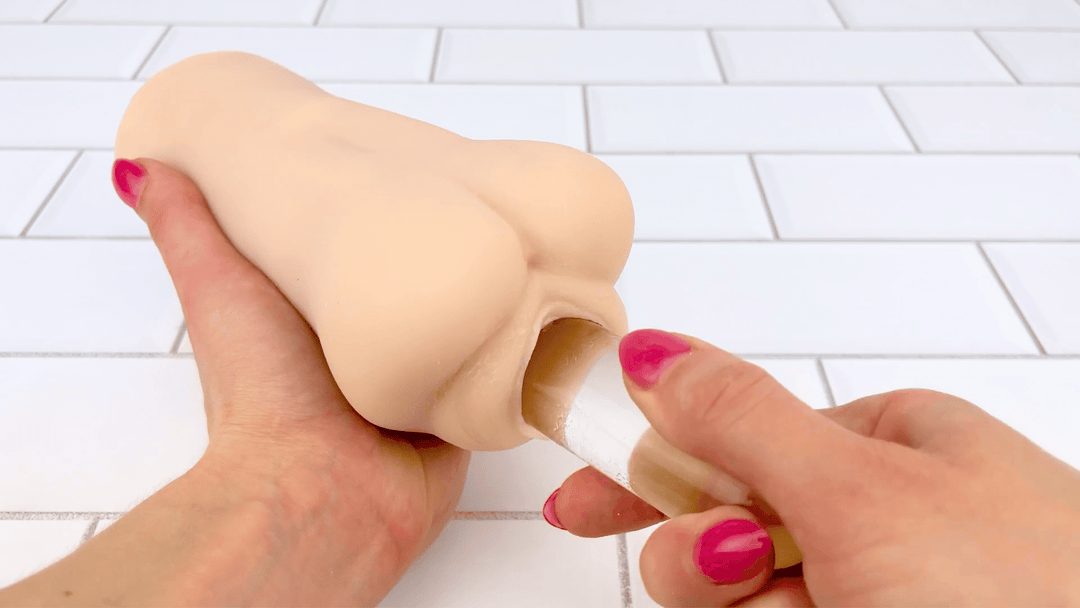 GIF of Realistic Stroker Sleeve - Open-ended Design Can Handle Any Size glass dildo sliding in and out 