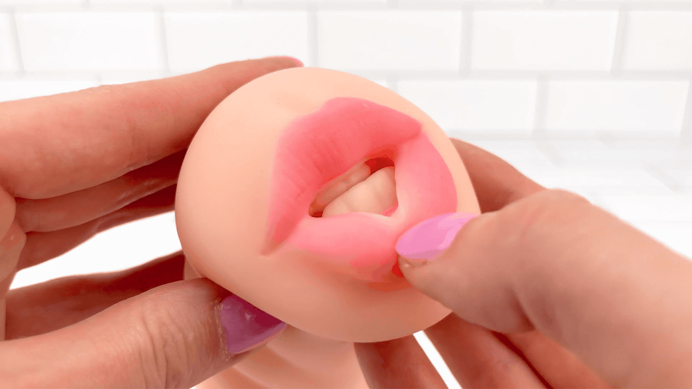 GIF of thumb brushing against lips from  Blowjob and Pussy Dual Ended Masturbator 