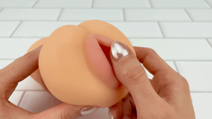 GIF of outer lips from Ultra Real Feel Pussy Stroker by TooTimid being brushed to show inside 