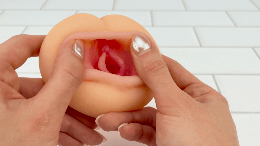 GIF of lips being stretched from Ultra Real Feel Pussy Stroker to show labia and clitoris 