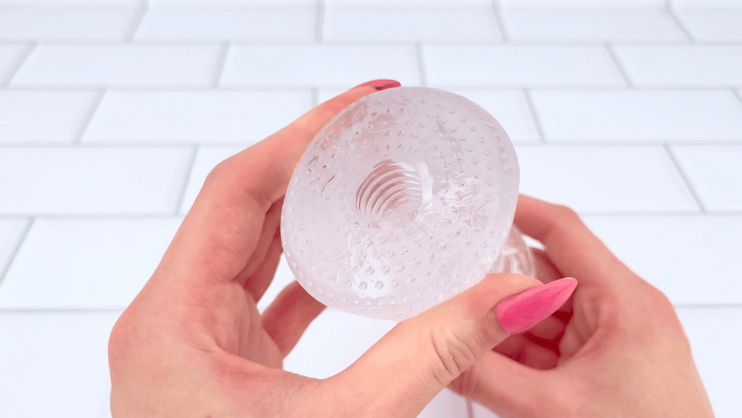 GIF of Super Stretchy Clear Ribbed Male Masturbator opening being squished made form soft jelly material 