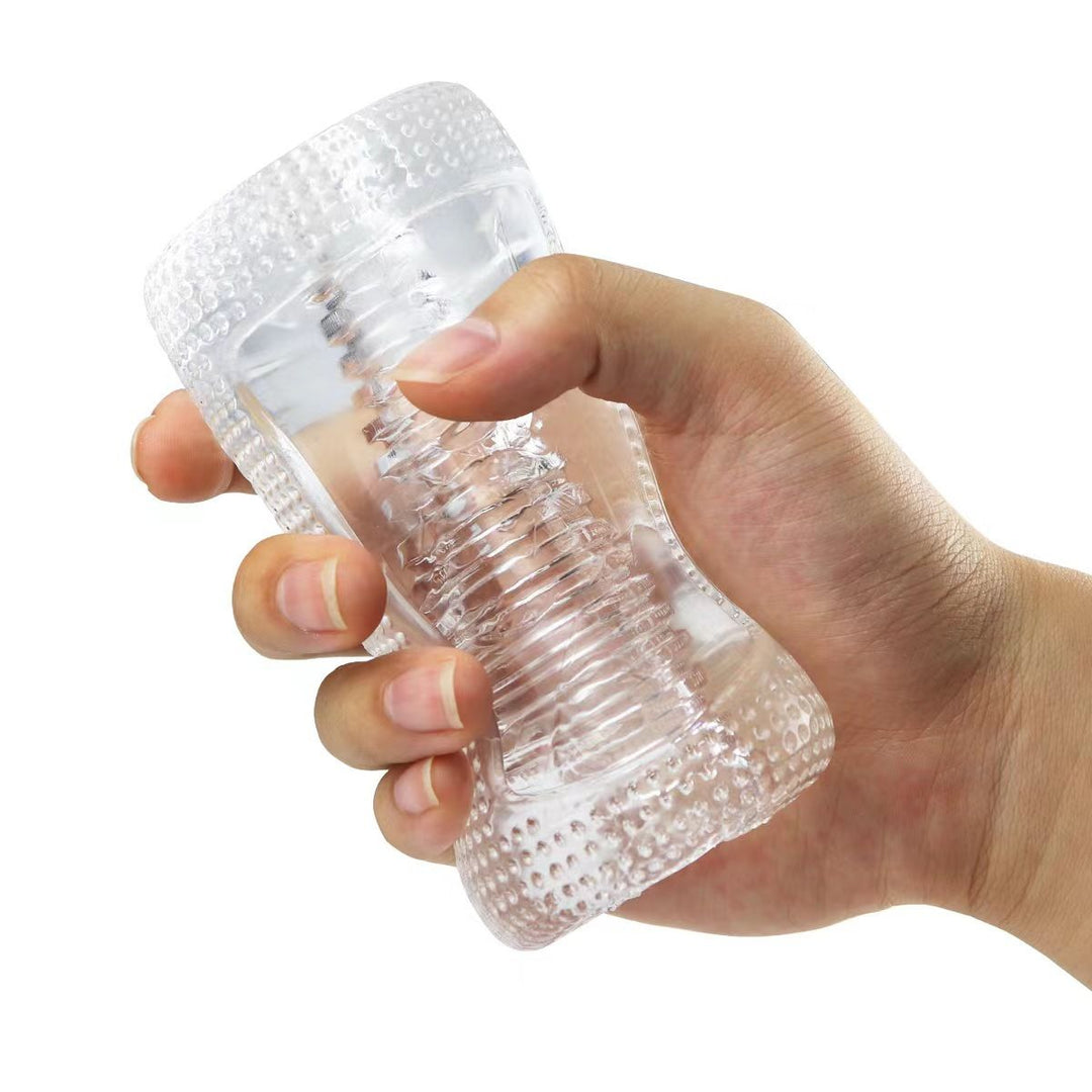 Super Stretchy Clear Ribbed Male Masturbator held in a hand being squeezed to show flexibility.
