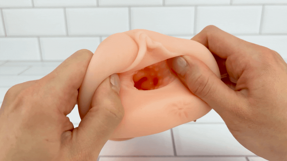 GIF of Handheld Pussy Masturbator realistic opening being stretched to show textured interior 