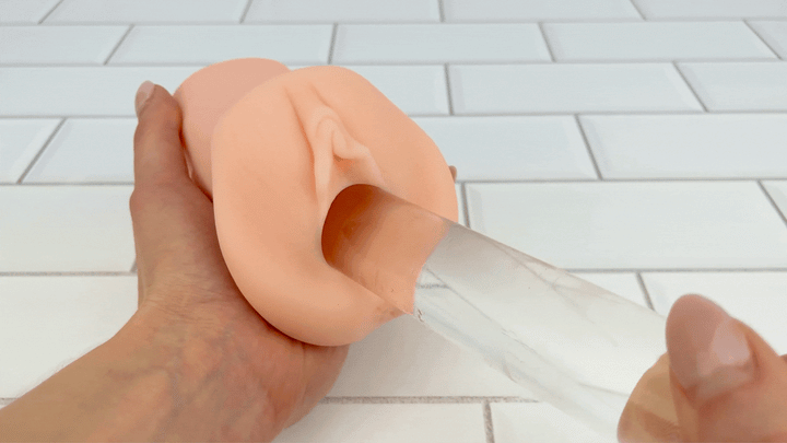 GIF of glass dildo thrusting into Handheld Pussy Masturbator 