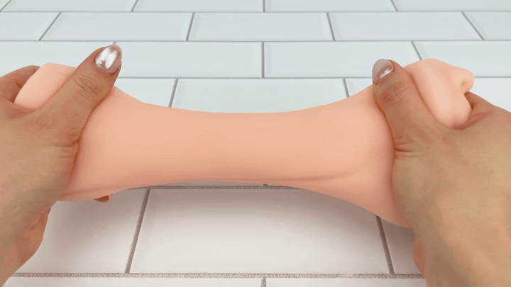 GIF of tube from Blowjob Masturbator being stretched to demonstrate soft material 