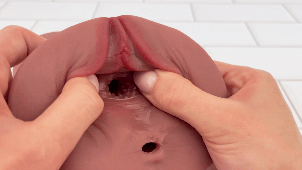GIF of Deep Desires Dual Entry Stroker vaginal entry being stretched open to show pleasure nubs 