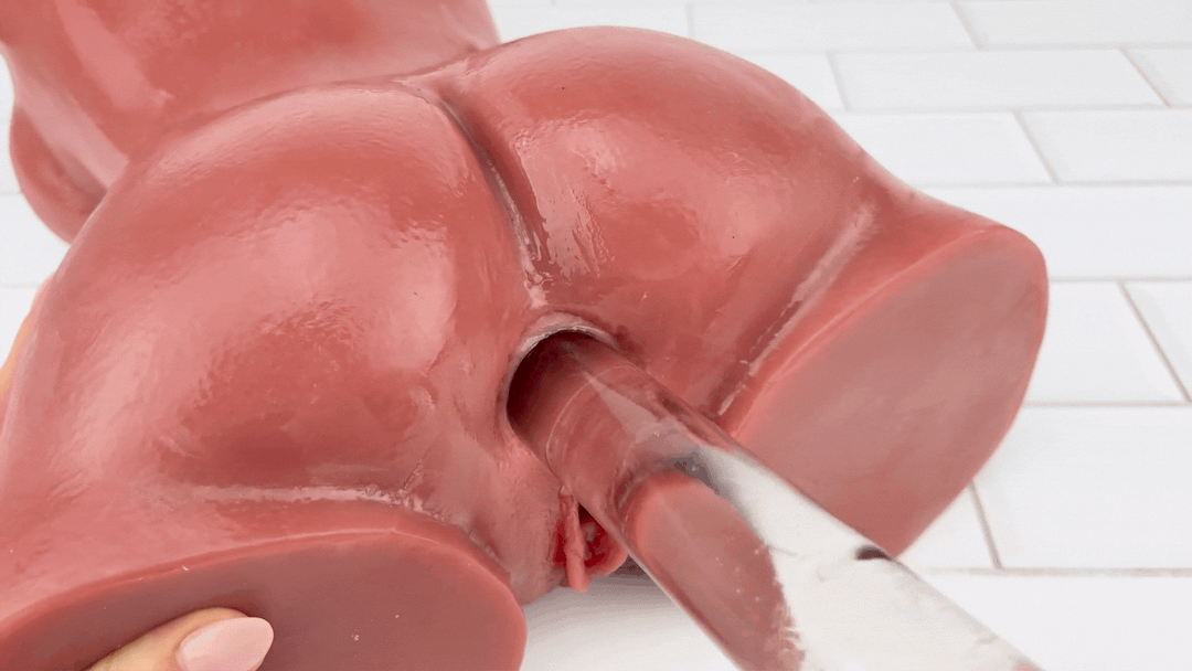 GIF of  tan male masturbator  anal tunnel being used with glass dildo 