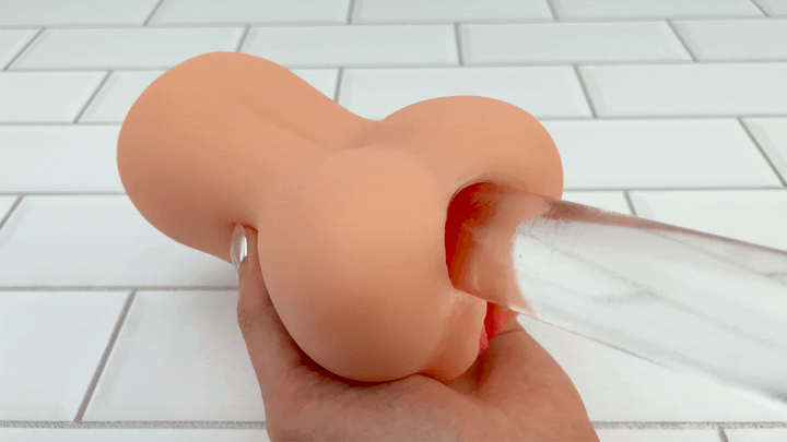 GIF of glass dildo from angled side view used on anal opening of Pussy and Ass male Stroker 