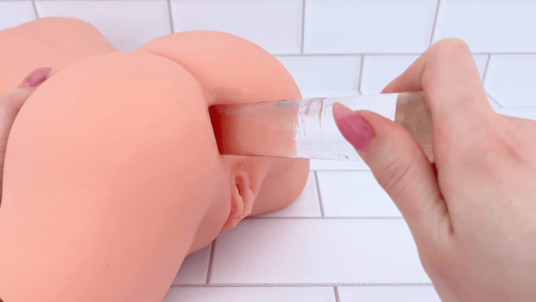 GIF of glass dildo sliding into anal entry of Lifelike Curvy Torso Masturbator 