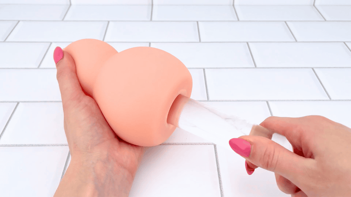 GIF of glass dildo sliding into Ultimate Real Feel Sucking Stroker 