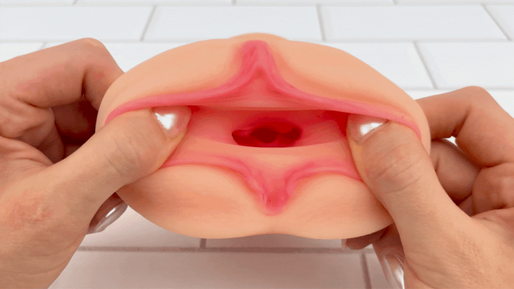 GIF of Dual Ended Stroking Sleeve - Tight Pussy opening being stretched to show textured interior 