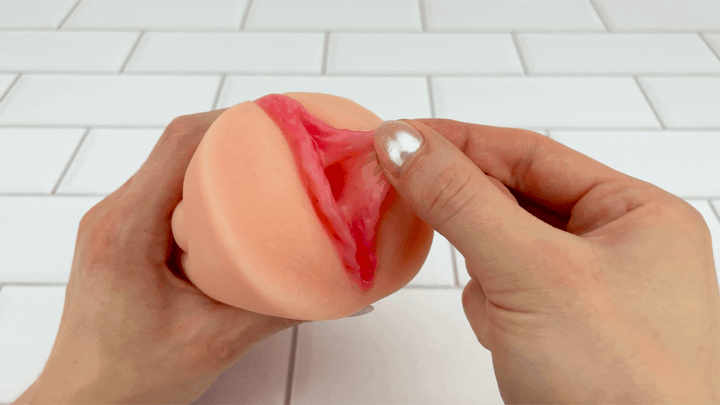 GIF of vaginal lips from Dual Ended Stroking Sleeve being pulled to show soft texture of sleeve 