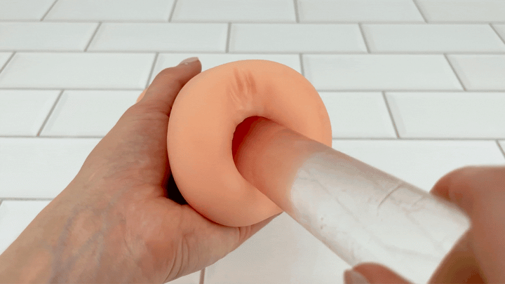 GIF of Dual Ended Stroking Sleeve - glass dildo sliding into anal opening 