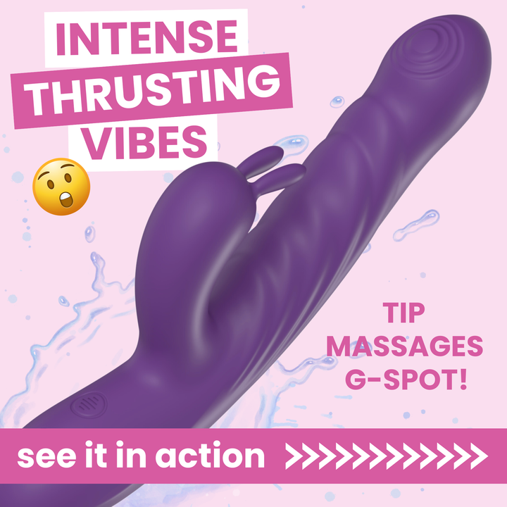 A purple silicone vibrating massager with a flared tip and small clitoral stimulator, shown on a pink background with promotional text reading 'INTENSE THRUSTING VIBES,' 'TIP MASSAGES G-SPOT!,' and 'see it in action.'.