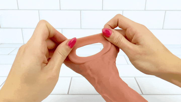 GIF of ball loop from Real Feel Vibrating Penis Extender being stretched 