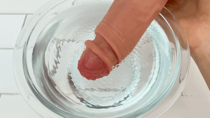 GIF of tip of Vibrating Penis Extender vibrating in bowl of water 