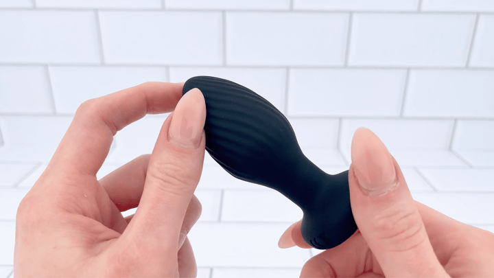 GIF of finger brushing against ripples from THE RIMMER Wireless Rotating and Rim Job Silicone Anal Plug  