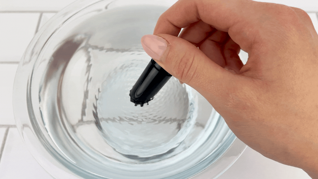 GIf of removeable bullet from Rippled Vibrating Silicone Cock Cage vibrating in bowl of water 