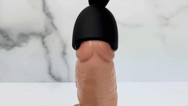 GIF of massager vibrating on the tip of a dildo