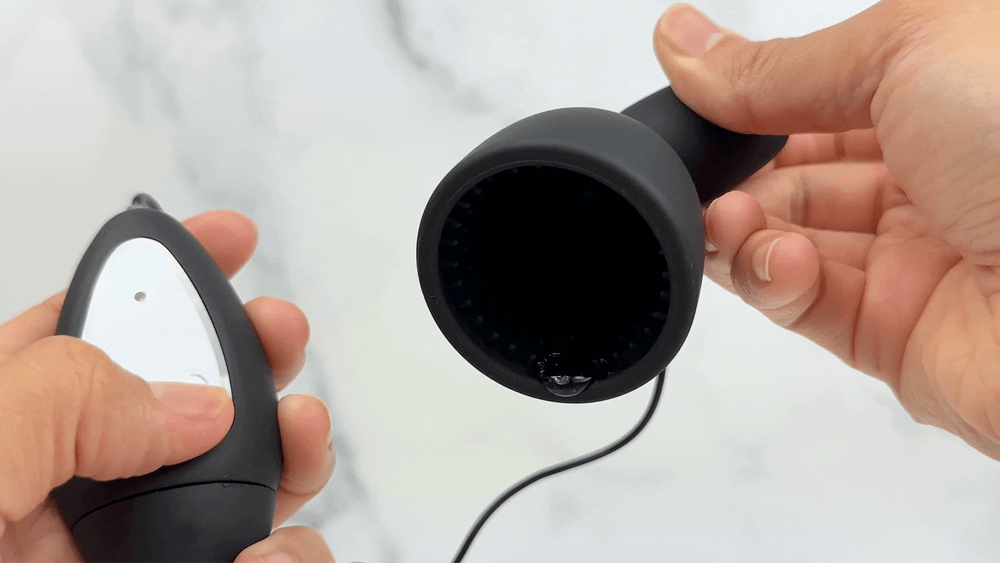 GIF of penis tip massager vibrating with lube inside of it