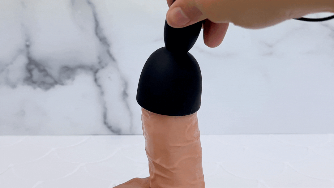 GIF of massager teasing the tip of a dildo