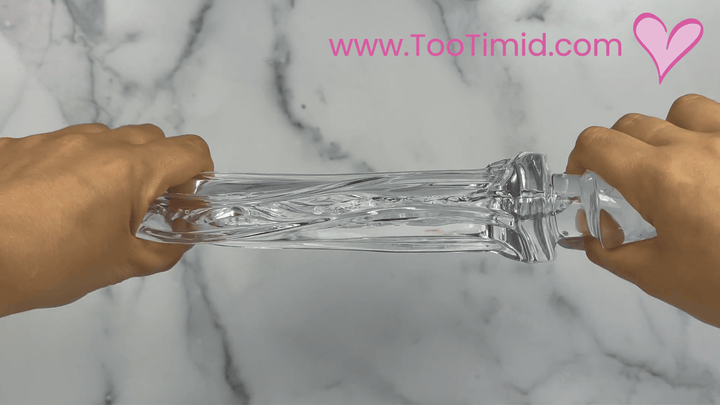 GIF of clear male masturbator out of cup stretching
