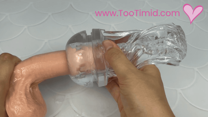 GIF of clear male masturbator out of cup stroking on beige dildo