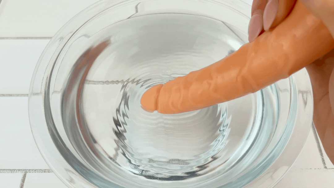 GIF of anal shaft from Clit Stimulating Dual Penetration Vibrating Dildo vibrating intensely in bowl of water 