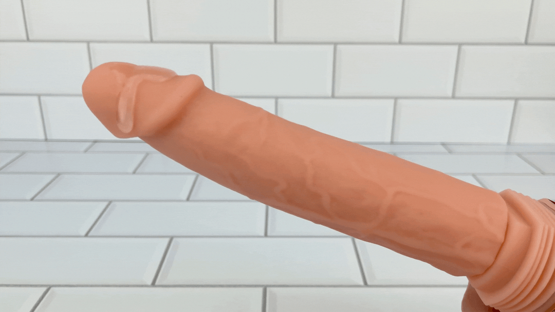 GIF of Hands-Free Thrusting & Vibrating Silicone Dildo lube vibrating on tip 