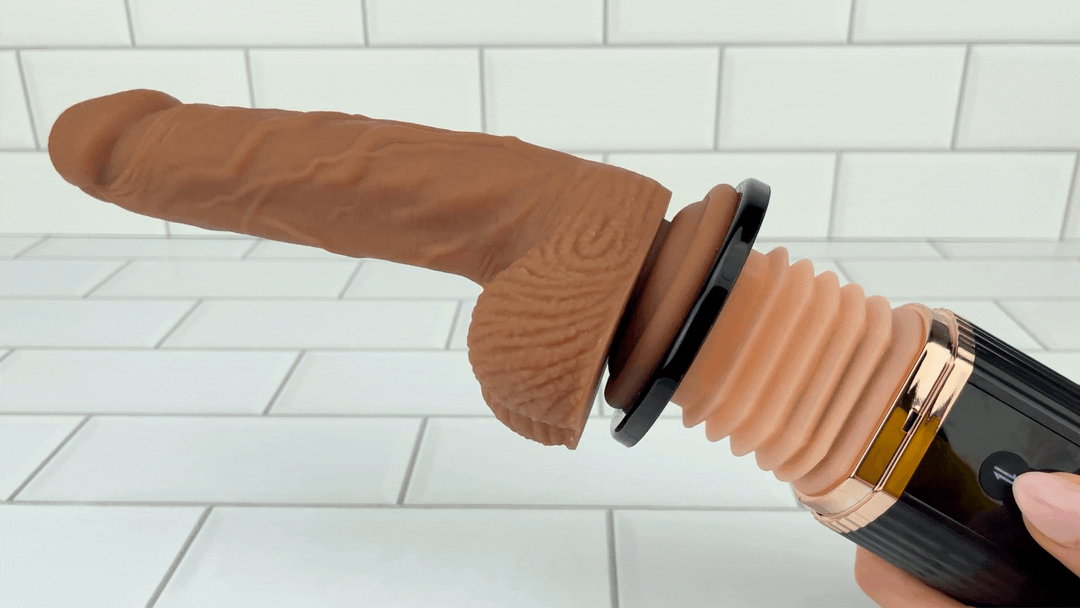 GIF of large dildo attached to flat base attachment thrusting 