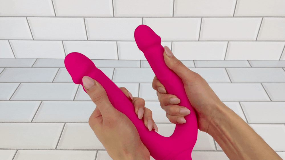GIF of hot pink double penetration vibrator  dongs being spread to show flexibility 